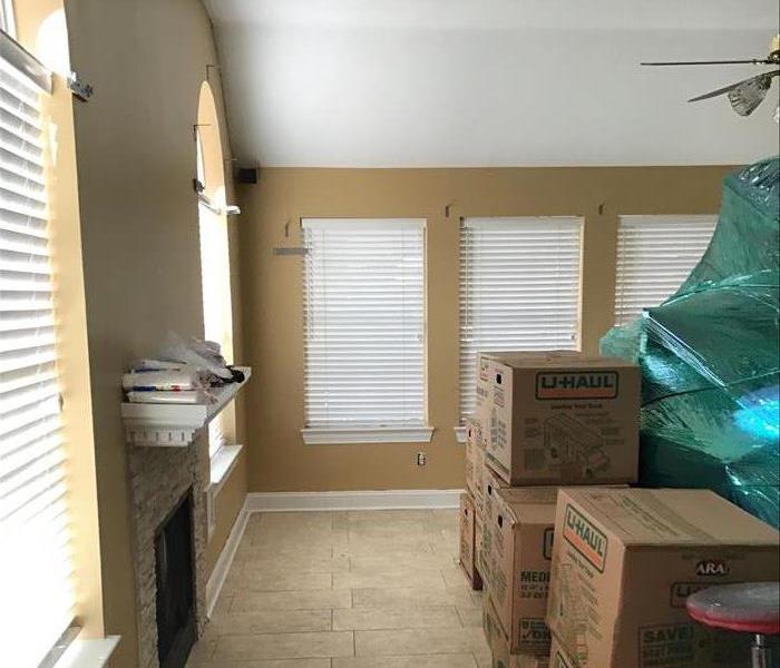 living room with items boxed to be removed from storm damage