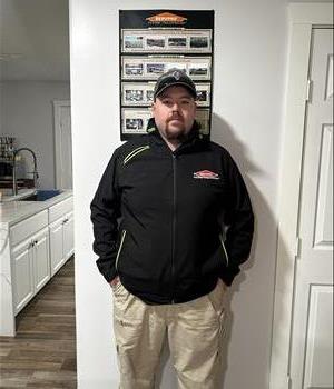 SERVPRO employee in black jacket posing for crew photo.
